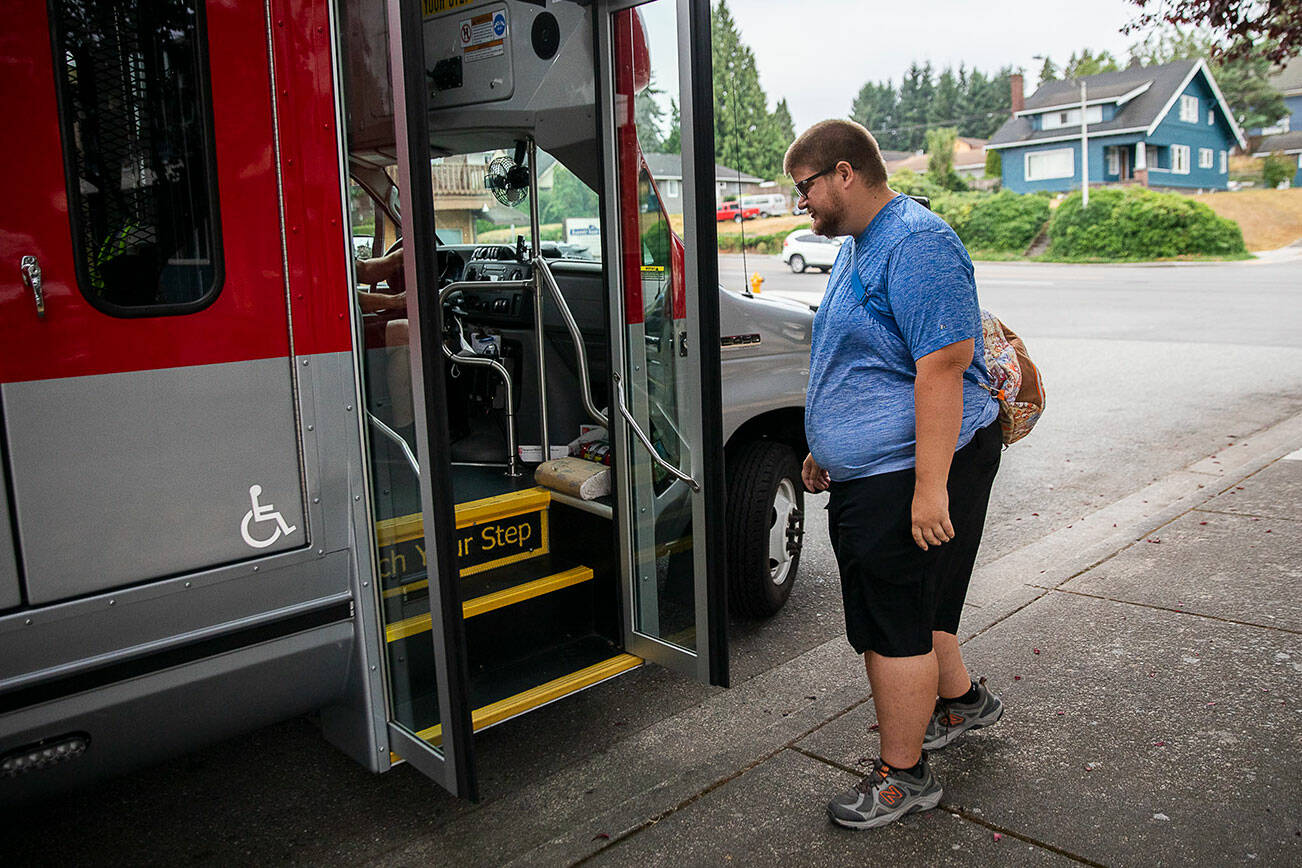 Doug Wennerberg boards the ParaTranist bus on Thursday, Sept. 1, 2022 in Everett, Washington. (Olivia Vanni / The Herald)