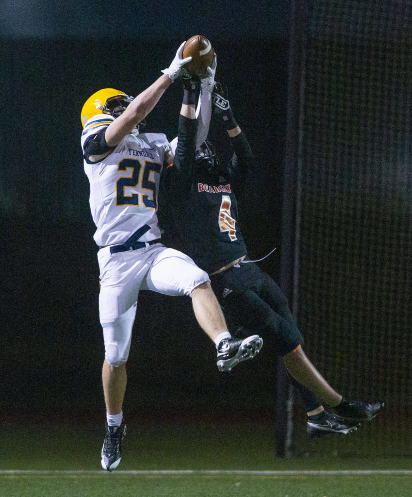 Monroe’s Gavin Ranz jumps to try and stop a catch during the game against Ferndale on Friday, Oct. 28, 2022 in Monroe, Washington. (Olivia Vanni / The Herald)
