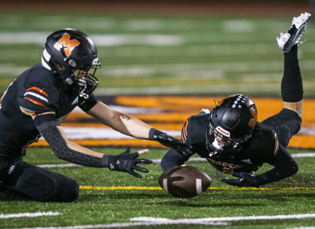 Monroe’s Mason Davis reaches out for a fumbled ball during the game against Ferndale on Friday, Oct. 28, 2022 in Monroe, Washington. (Olivia Vanni / The Herald)
