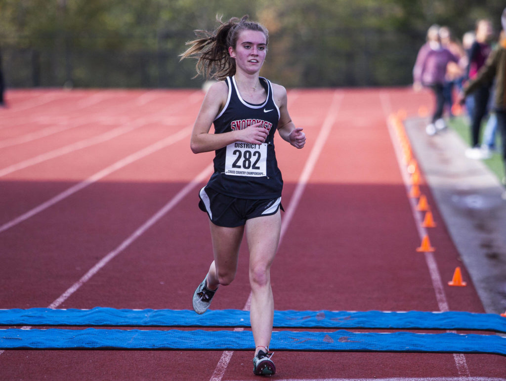 Snohomish’s Paige Gerrard crosses the finish line with no other racers near her to win the 3A Girls District Cross Country championship race on Saturday, Oct. 29, 2022 in Arlington, Washington. (Olivia Vanni / The Herald)
