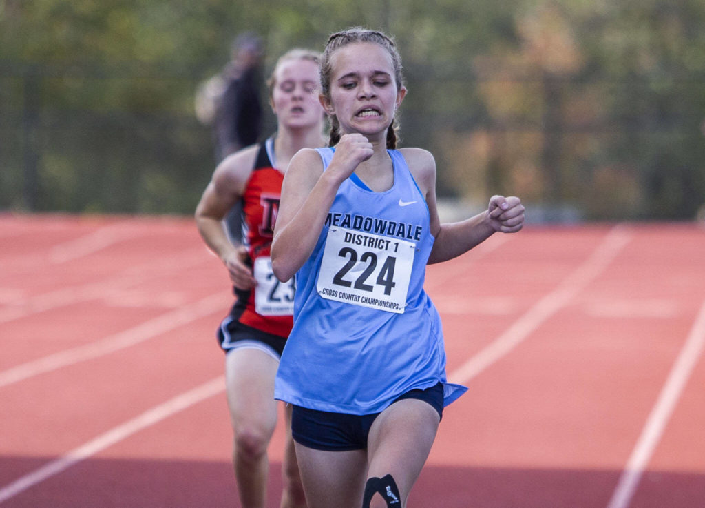Meadowdale’s Payton Conover crosses the finish line to get third in the 3A Girls District Cross Country championship race on Saturday, Oct. 29, 2022 in Arlington, Washington. (Olivia Vanni / The Herald)
