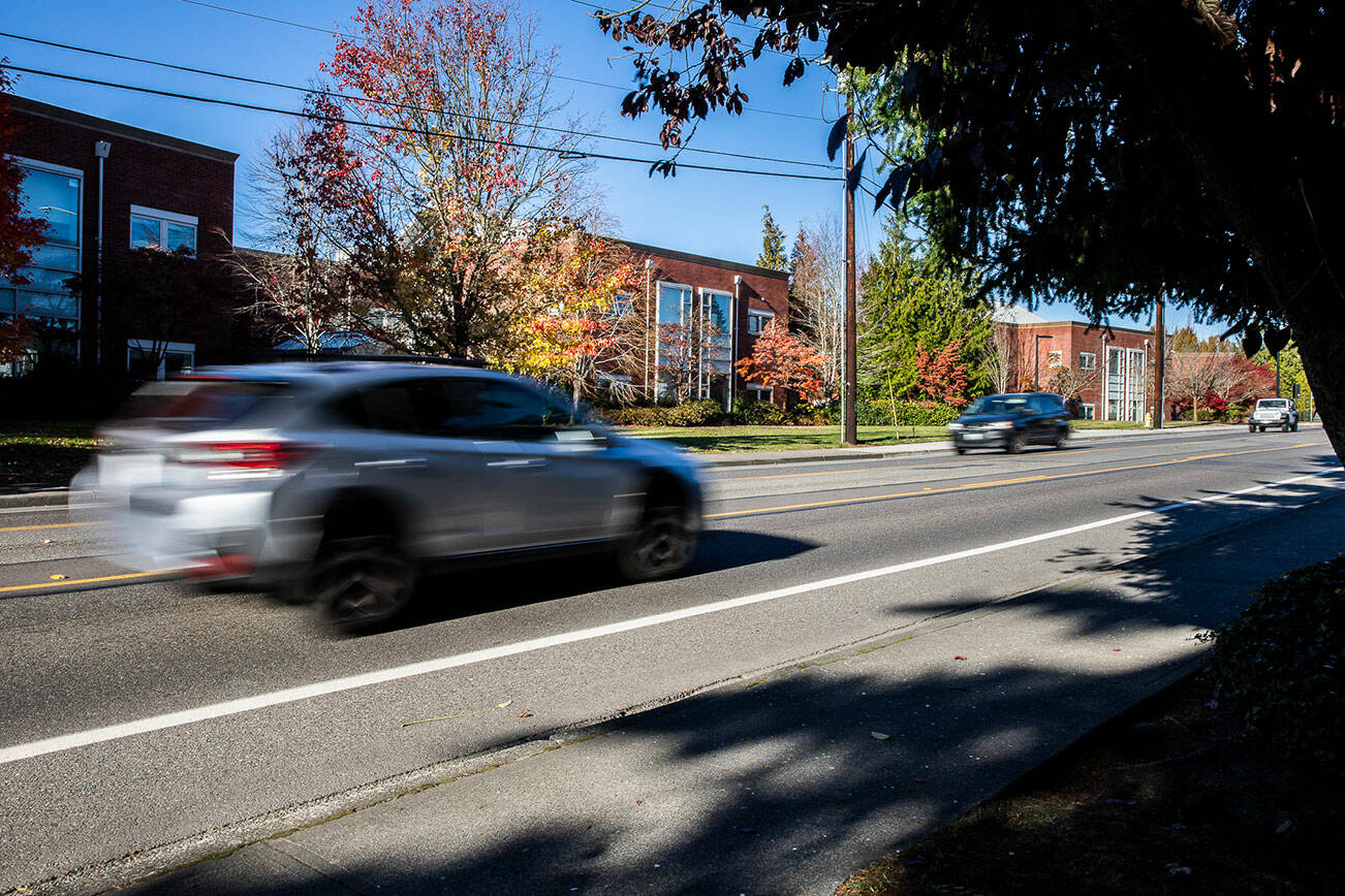 Cars drive along 76th Avenue West in front of Edmonds-Woodway High School on Friday, Nov. 18, 2022 in Edmonds, Washington. (Olivia Vanni / The Herald)