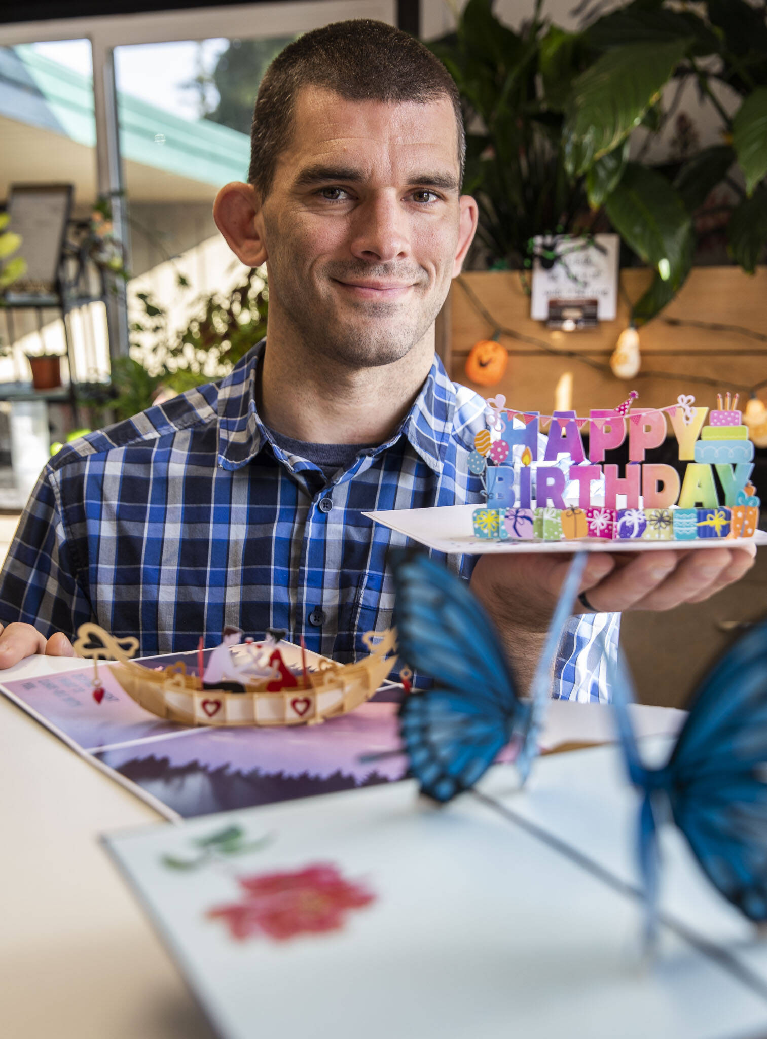 Andy Illyn with a selection of his greeting cards, Cardstalked, that are sold at What’s Bloomin’ Floral on Oct. 28, in Arlington. (Olivia Vanni / The Herald)