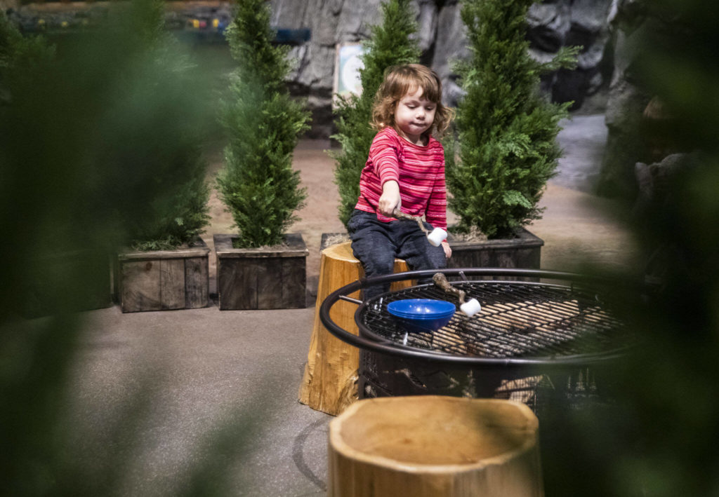 Giulia Martins, 2, pretends to roast a marshmallow at the Imagine Children’s Museum on Oct. 26, in Everett. (Olivia Vanni / The Herald)
