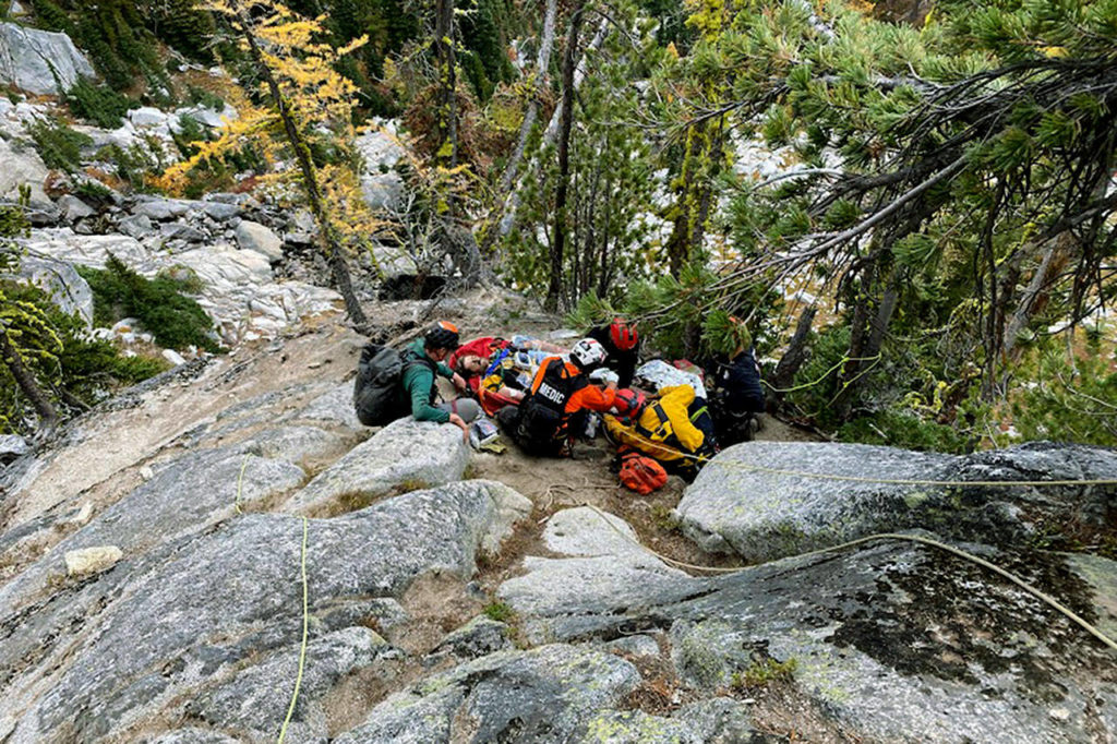Search and rescue crews provide medical aid to Benedict Delahunty after he is freed from underneath a 4,000 pound boulder on Oct. 10. (Snohomish County Helicopter Rescue Team)
