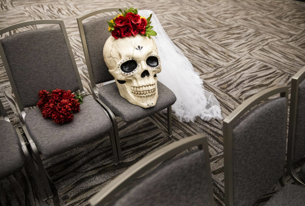 A large decorative skull with roses and a veil occupies an empty seat during the Washington-Guerrero Foundation’s Día de los Muertos event at the Lynnwood Convention Center on Saturday, in Lynnwood. (Olivia Vanni / The Herald)
