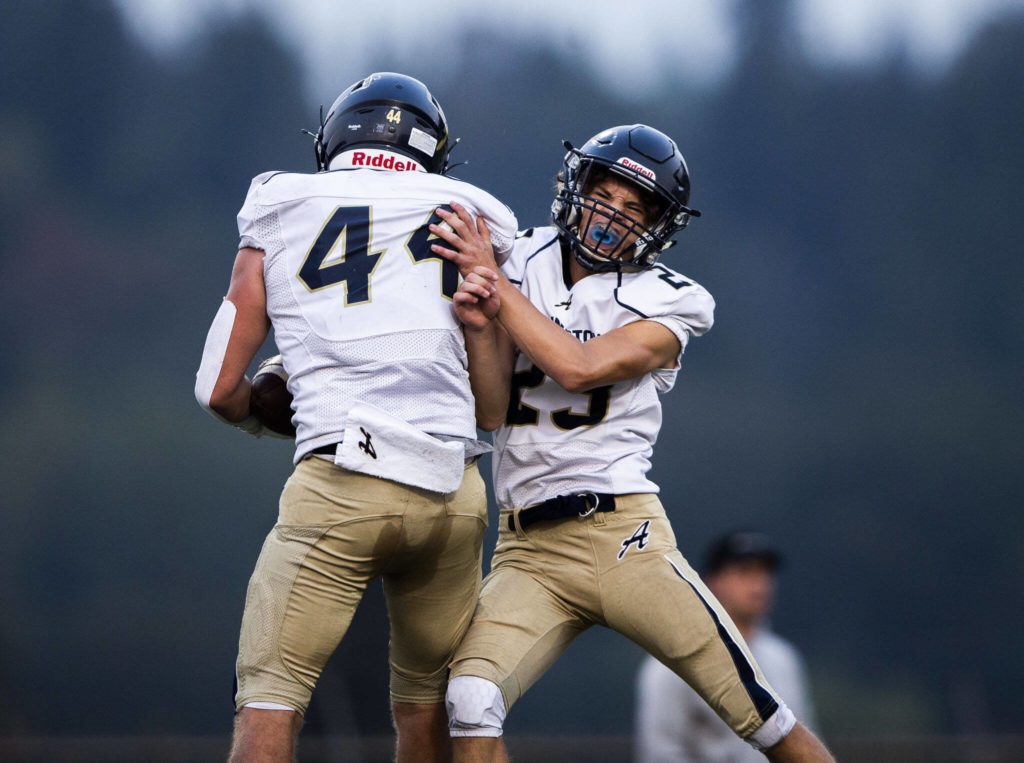 Arlington’s Spencer Fischer celebrates a touchdown with teammate Chase Deberry during the game against Marysville Getchell on Sept. 9 at Quil Ceda Stadium in Marysville. The Eagles travel to Gig Harbor to battle with Peninsula on Friday.(Olivia Vanni / The Herald)
