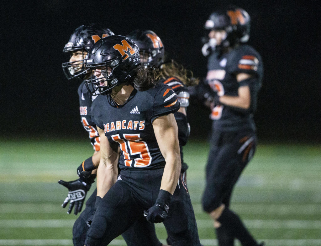 Junior Nick Mouser (15) and his Monroe teammates celebrate a stop on fourth down during the game against Ferndale on Oct. 28 in Monroe. Mouser and the Bearcats face Liberty (Renton) on Friday. (Olivia Vanni / The Herald)
