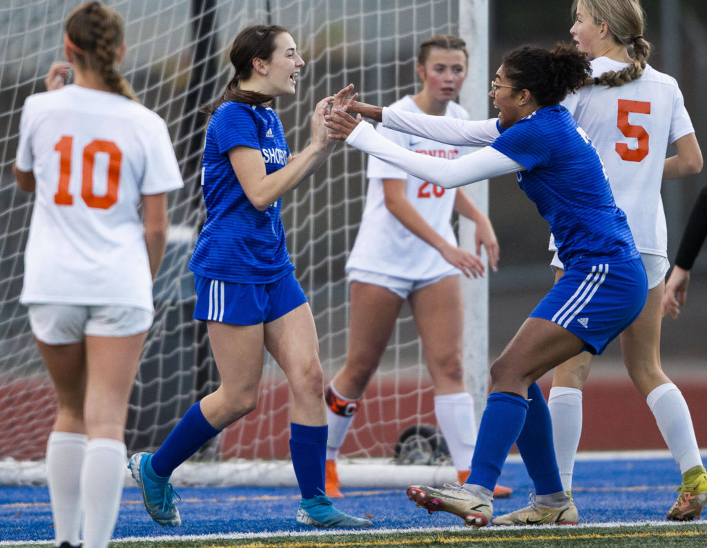 Shorewood’s Diana Tuilevuka, right, runs to congratulate teammate Molly McGeoy on her goal during game against Monroe on Tuesday, Nov. 1, 2022 in Shoreline, Washington. (Olivia Vanni / The Herald)
