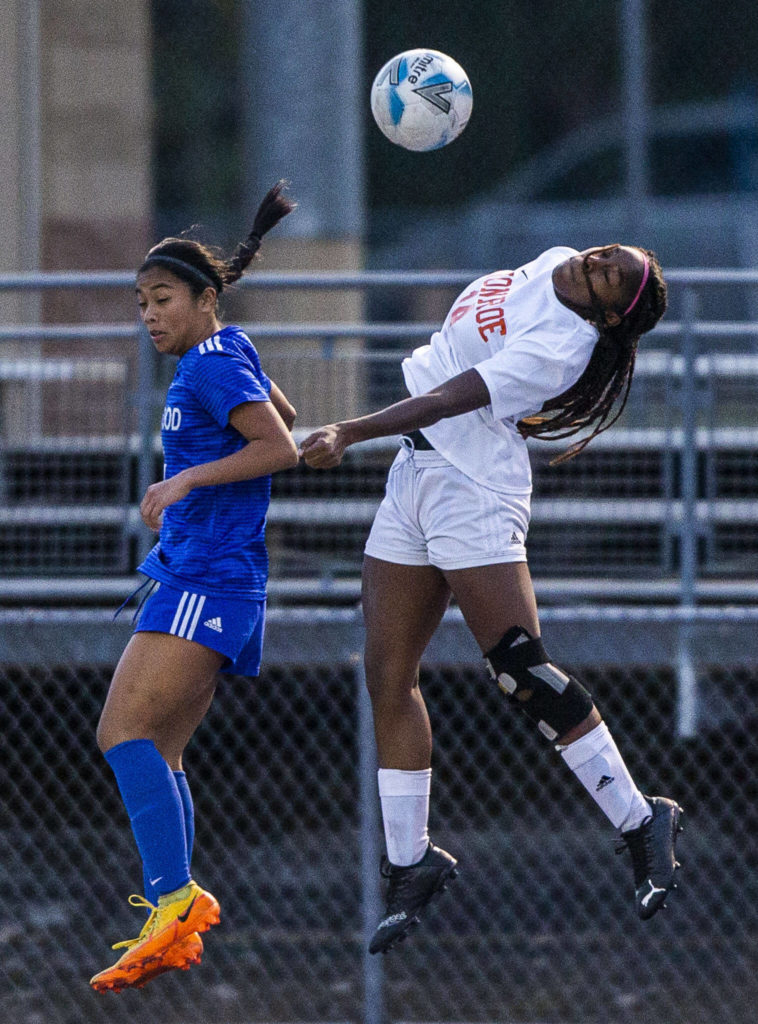 Monroe’s Halle Keller leaps for a head ball during game against Shorewood on Tuesday, Nov. 1, 2022 in Shoreline, Washington. (Olivia Vanni / The Herald)
