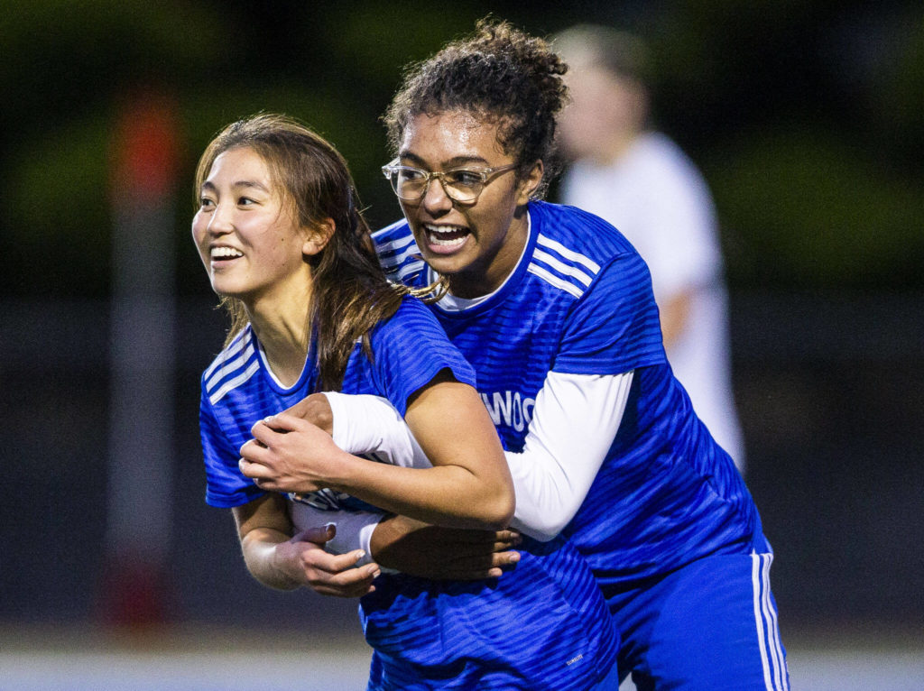 Shorewood’s Diana Tuilevuka, right, hugs teammate Cary Tanaka after she scores during game against Monroe on Tuesday, Nov. 1, 2022 in Shoreline, Washington. (Olivia Vanni / The Herald)
