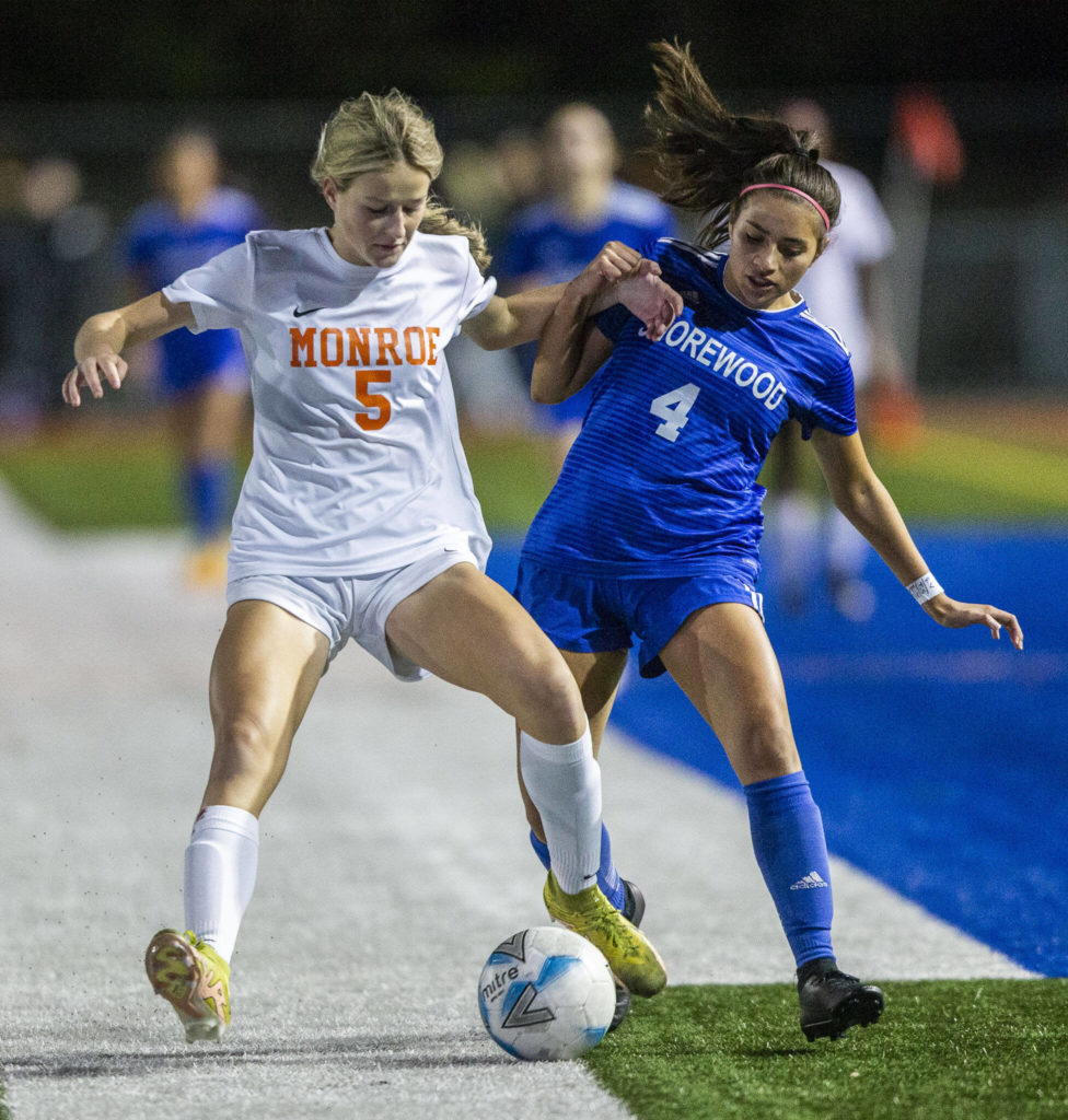 Monroe’s Faith Gunter fights for the ball with Shorewood’s Isabella Valenzuela during game on Tuesday, Nov. 1, 2022 in Shoreline, Washington. (Olivia Vanni / The Herald)
