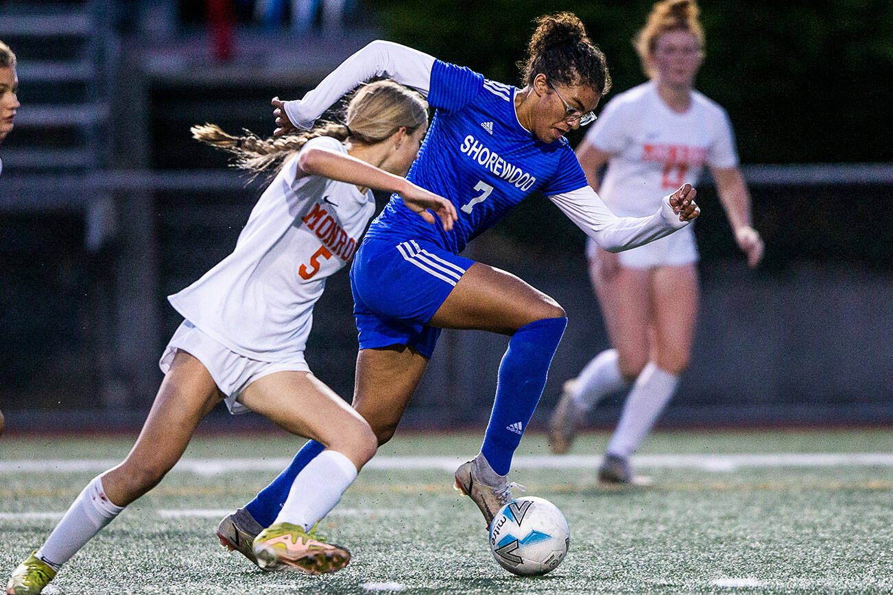 Shorewood’s Diana Tuilevuka maneuvers around Monroe defender Faith Gunter to shoot and score during game on Tuesday, Nov. 1, 2022 in Shoreline, Washington. (Olivia Vanni / The Herald)