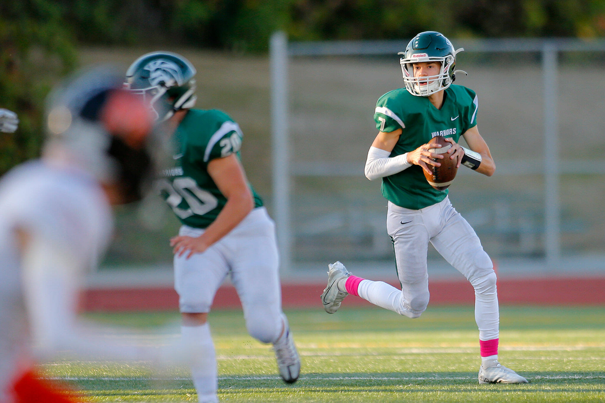 Edmonds-Woodway’s Steven Warren Jr. rolls out of the pocket while looking to pass against Monroe on Oct. 14 at Edmonds School District Stadium. Warren leads the area in passing yards and is third in passing touchdowns. (Ryan Berry / The Herald)