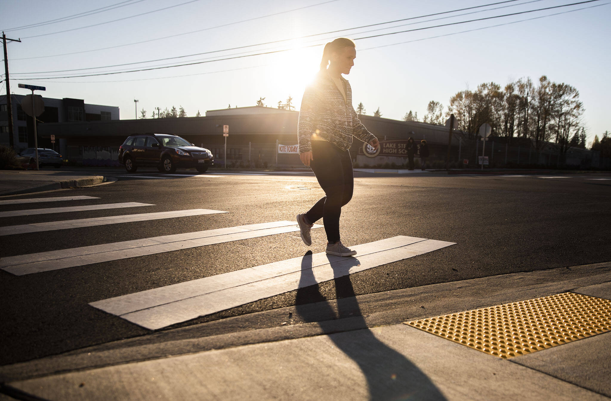 A pedestrian uses the crosswalk at 30th Street NE along 113th Avenue NE near Lake Stevens High School on Monday, in Lake Stevens. (Olivia Vanni / The Herald)