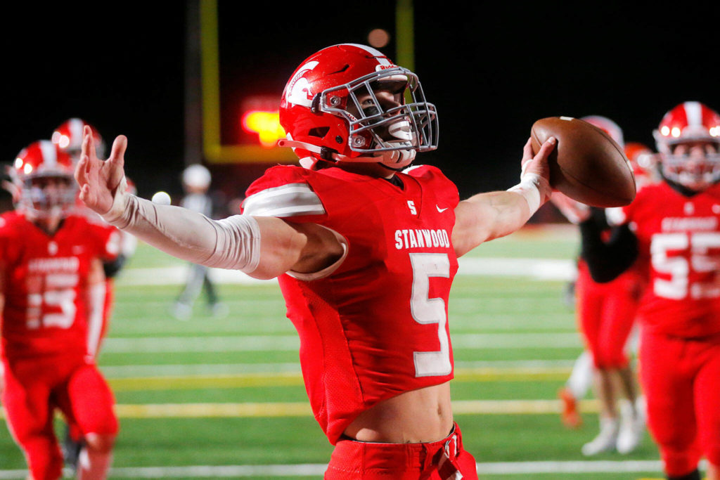 Stanwood senior running back Ryder Bumgarner celebrates after taking a handoff in for a touchdown during the first half against Lakes High School on Friday, Nov. 4, 2022, at Stanwood High School in Stanwood, Washington. (Ryan Berry / The Herald)
