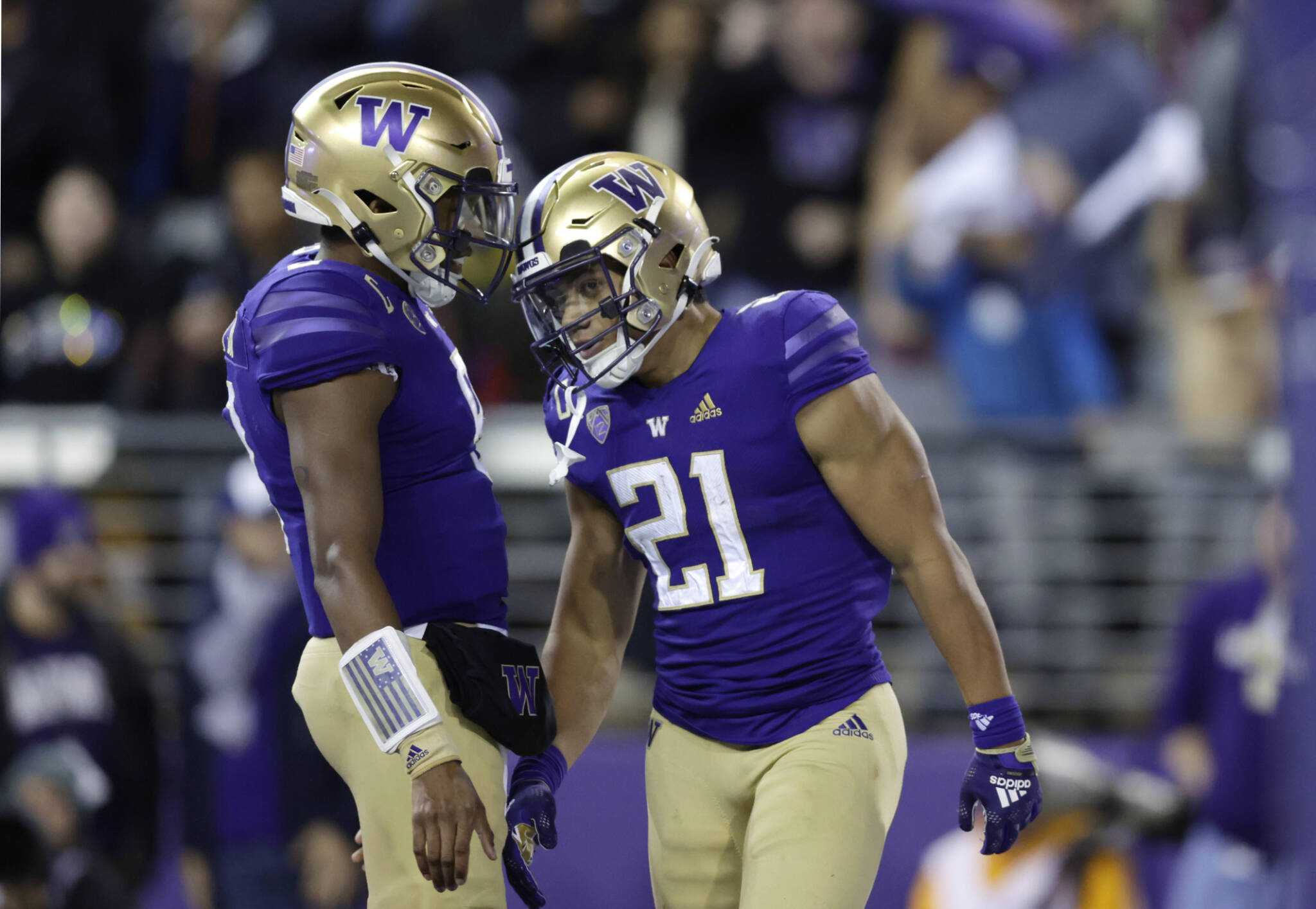 Washington running back Wayne Taulapapa (21) celebrates his touchdown against Oregon State with quarterback Michael Penix Jr. (9) during the first half of a game Friday in Seattle. (AP Photo/John Froschauer)