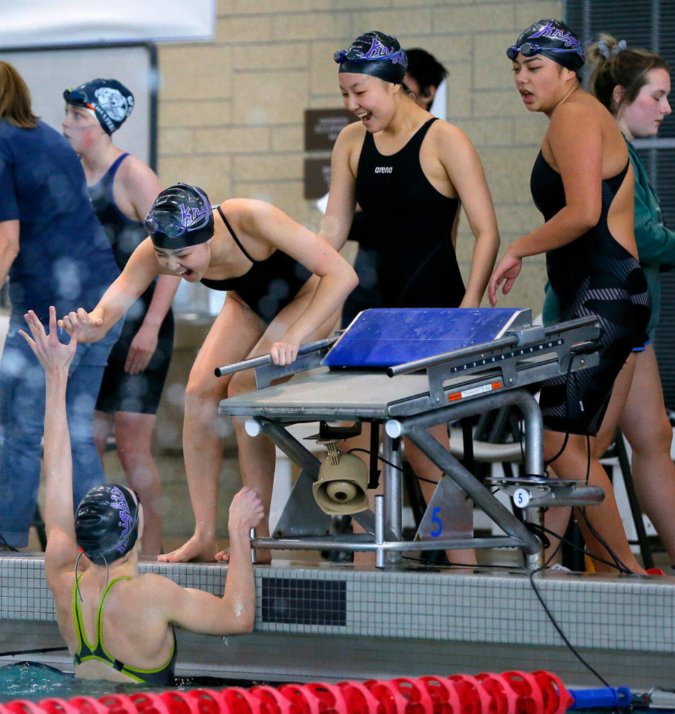 The Kamiak freestyle relay team celebrates a strong finish during the Class 4A District 1 swim meet Saturday, Nov. 5, 2022, at Snohomish Aquatic Center in Snohomish, Washington. (Ryan Berry / The Herald)
