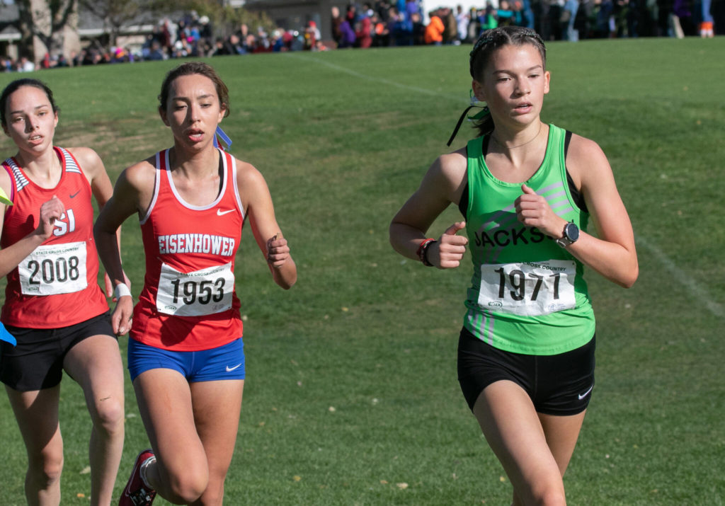 Jackson’s Emma Hamm (right) finishes 12th in the 4A girls state cross country meet on Saturday at Sun Willows Golf Course in Pasco. (TJ Mullinax / For The Herald)
