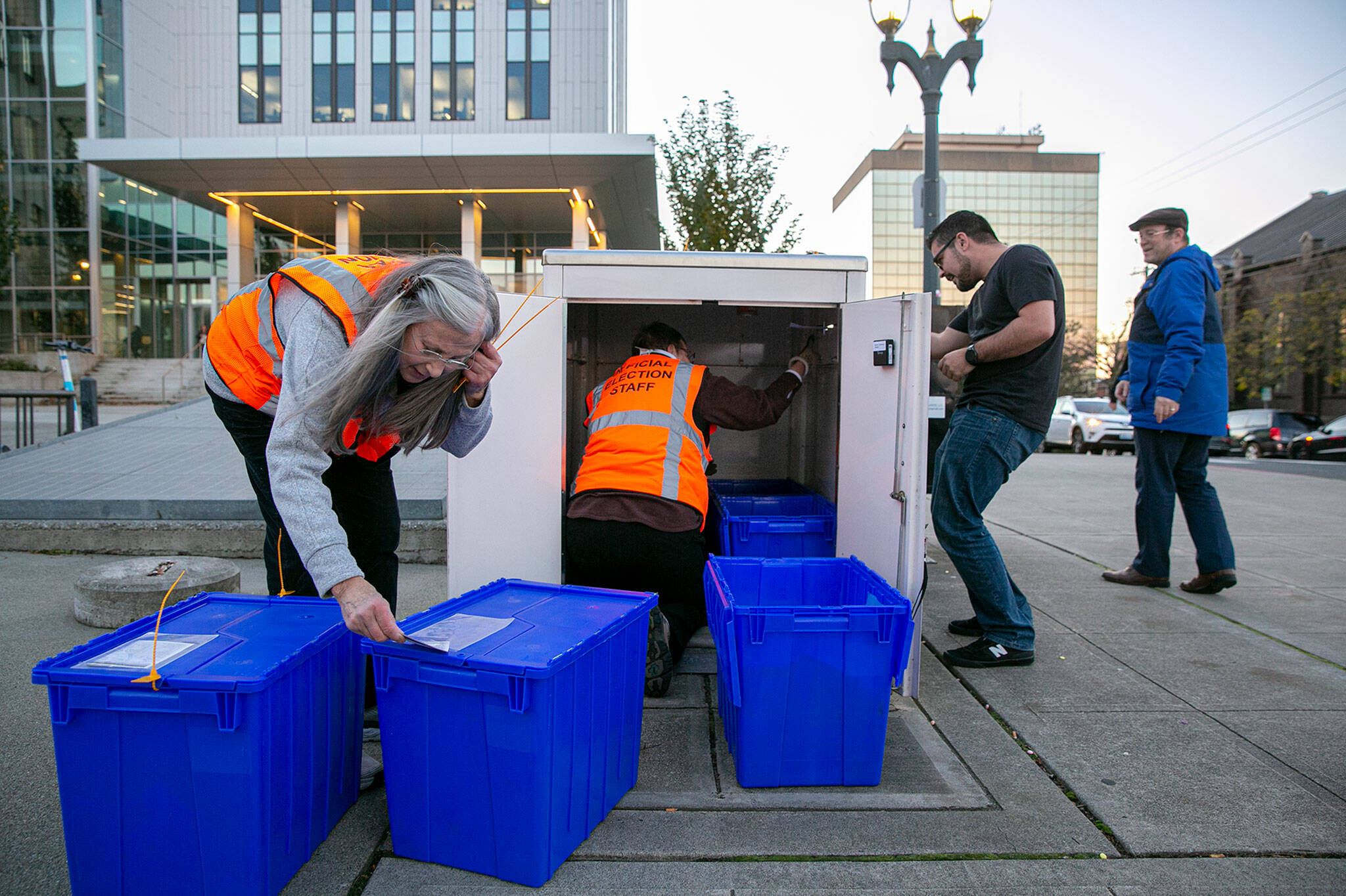 Two Snohomish County election workers empty the downtown Everett ballot box and lock the ballots in containers as voters continued to cast their votes in the final hours of Tuesday’s election. Meanwhile, hundreds of people filled out ballots throughout the day at the satellite voting center inside the county Administration Building. County Auditor Garth Fell said it was a busy day but there were no reports of security issues with ballots. Election officials expect a final turnout around 70 percent. (Ryan Berry / The Herald)