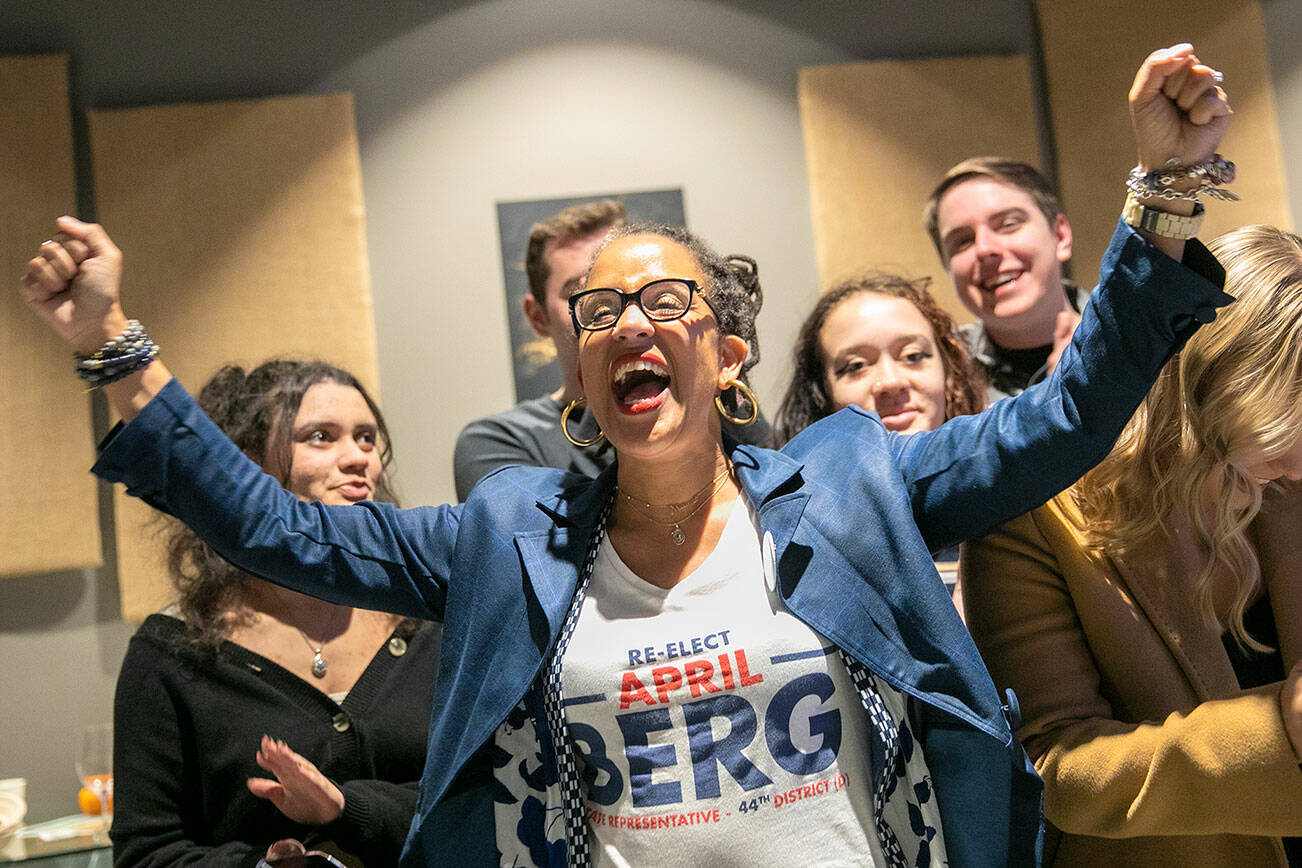 April Berg, alongside her family, cheers as first results are read aloud during a midterm election night watch party on Tuesday, Nov. 8, 2022, at Laters Winery in Snohomish, Washington. (Ryan Berry / The Herald)