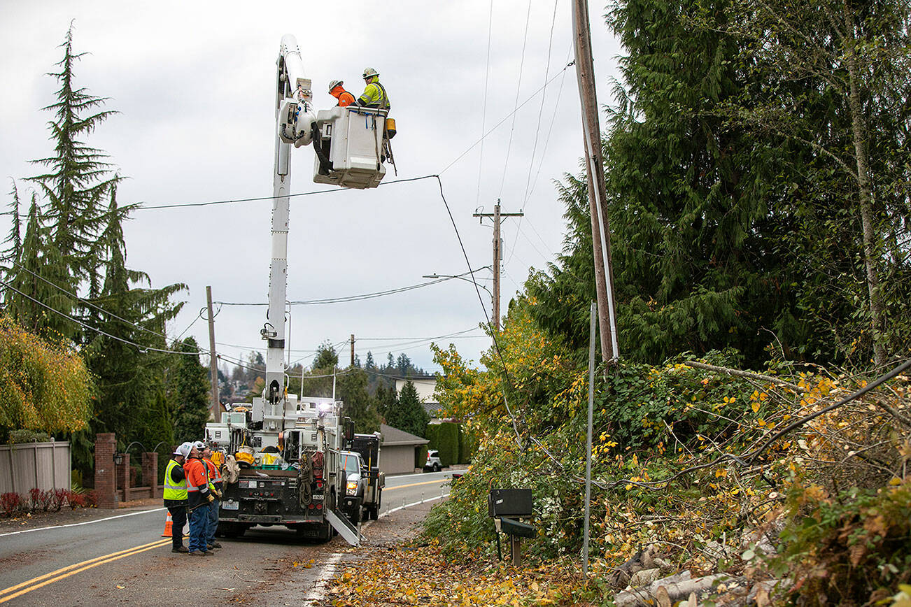 A Snohomish County PUD line crew works to fix power lines and restore electricity to a neighborhood along North Davies Road on Monday, Nov. 7, 2022, in Lake Stevens, Washington. (Ryan Berry / The Herald)