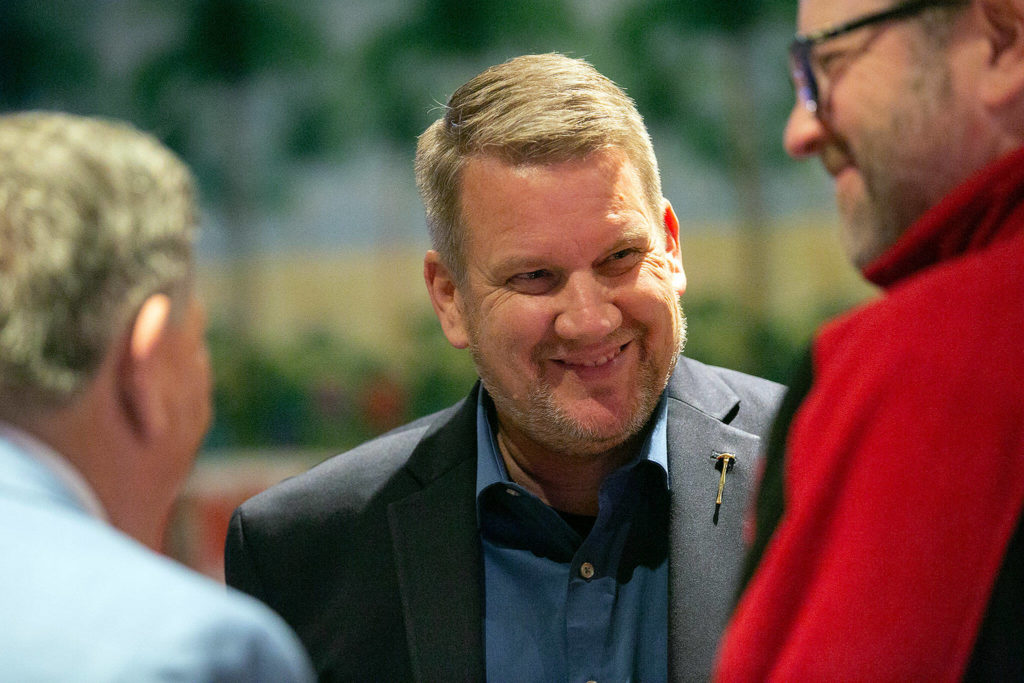 Sam Low chats with a pair of supporters as people stream into a midterm election night watch party on Nov. 8, at Papa’s Mexican Grill in Lake Stevens. (Ryan Berry / The Herald)
