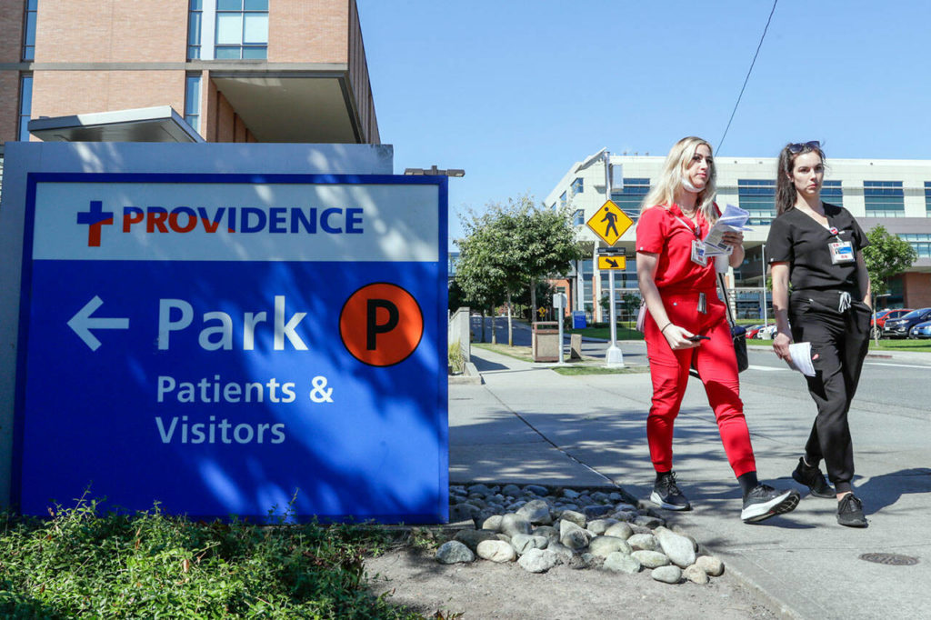 Providence employees on August 24 walk to a rally about work conditions at the hospital in Everett. (Kevin Clark / Herald file)
