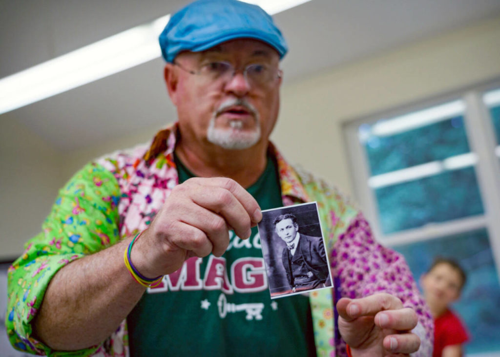 Magician JR Russell shows a picture of famous escape artist Harry Houdini to his class. (David Welton)
