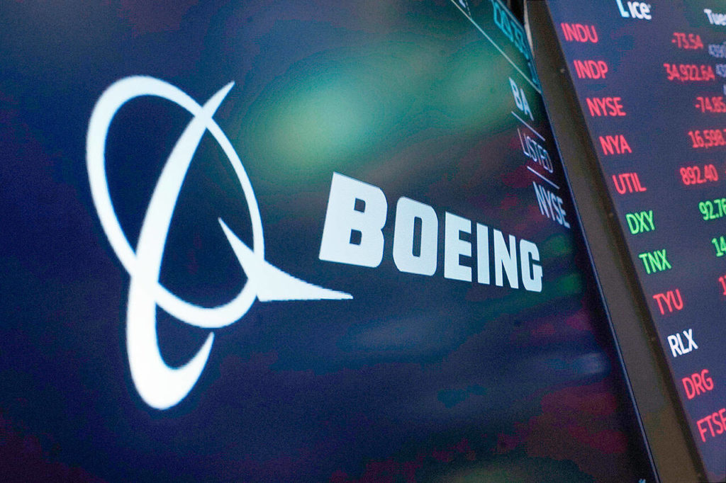 The logo for Boeing appears on a screen above a trading post on the floor of the New York Stock Exchange on July 13, 2021. (AP Photo / Richard Drew, file)