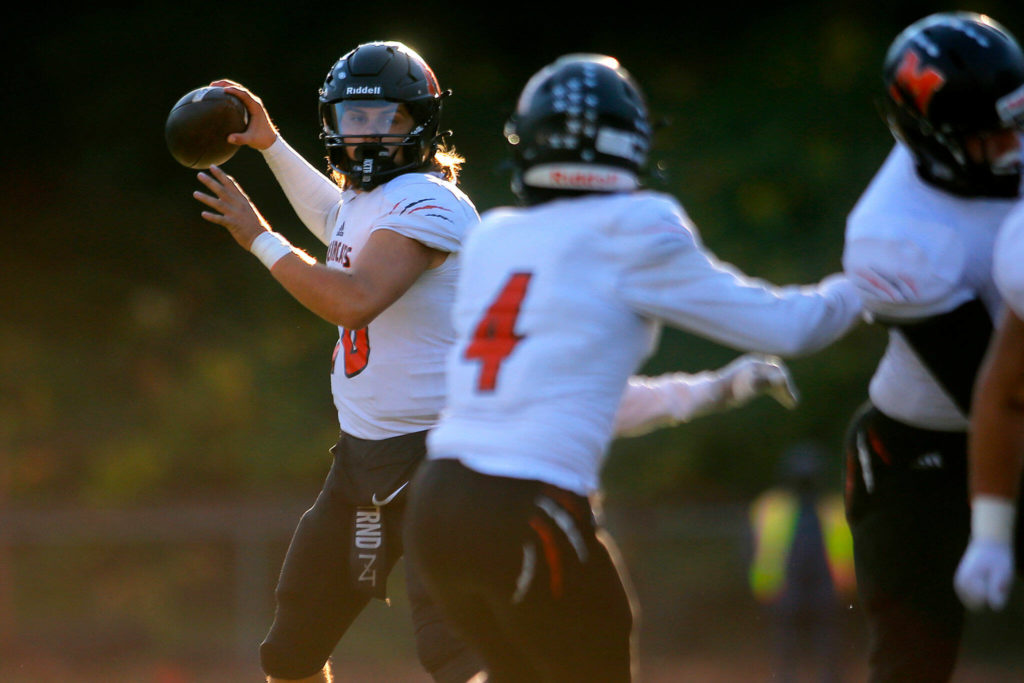 Monroe’s Blake Springer winds up to throw a short out pass during a playoff matchup against Lincoln High on Saturday, Nov. 12, 2022, at the Lincoln Bowl in Tacoma, Washington. (Ryan Berry / The Herald)
