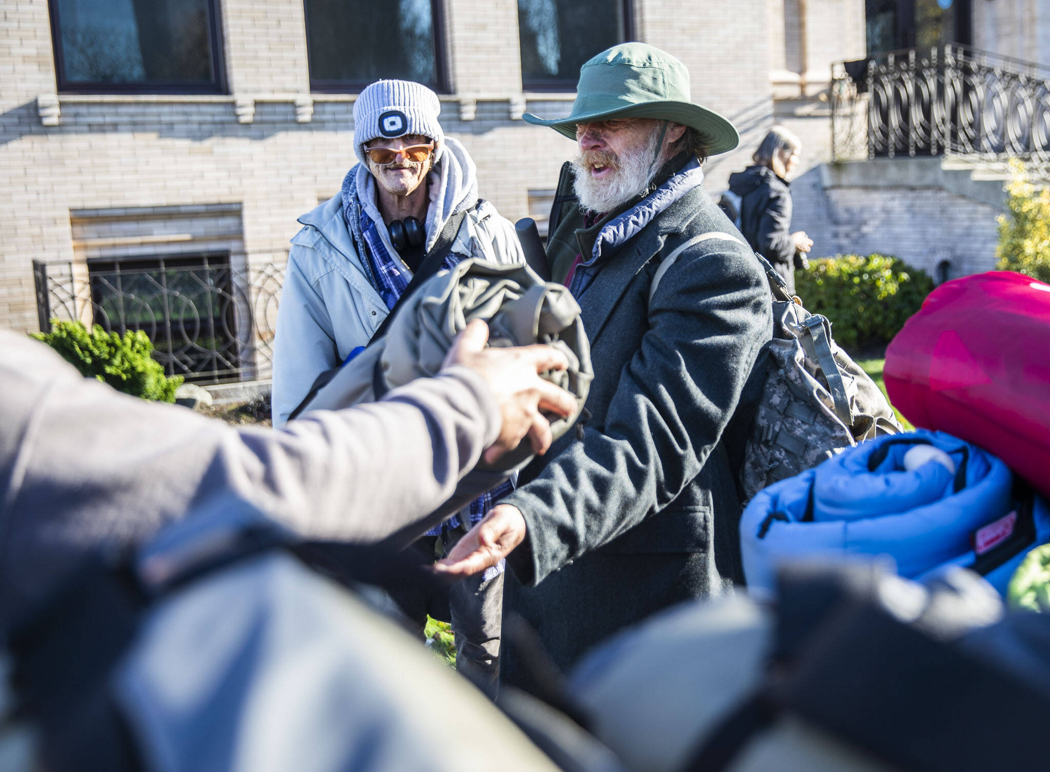 Timothy Gottschalk receives a ShelterSuit from Angel Resource Connection at the Carnegie Resource Center on Wednesday in Everett. (Olivia Vanni / The Herald)