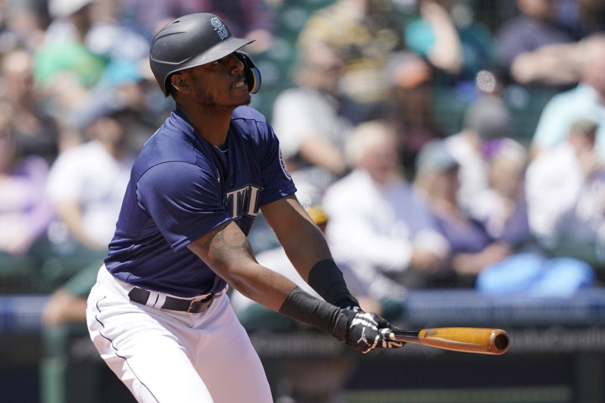 Seattle Mariners' Kyle Lewis watches his line-out during the second inning of a baseball game against the Oakland Athletics, Wednesday, May 25, 2022, in Seattle. (AP Photo/Ted S. Warren)