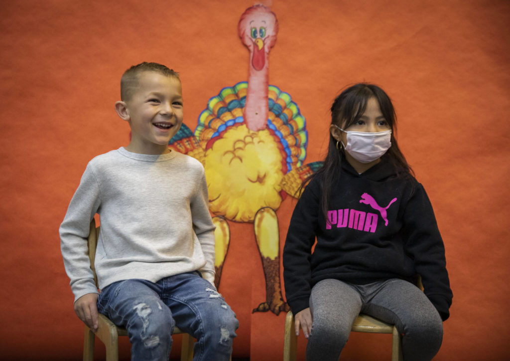 Kasen Clarke, left, and Chelsea Lopez-Romero, talk about what their favorite thanksgiving food is at Central Primary School on Tuesday, in Snohomish. (Olivia Vanni / The Herald)
