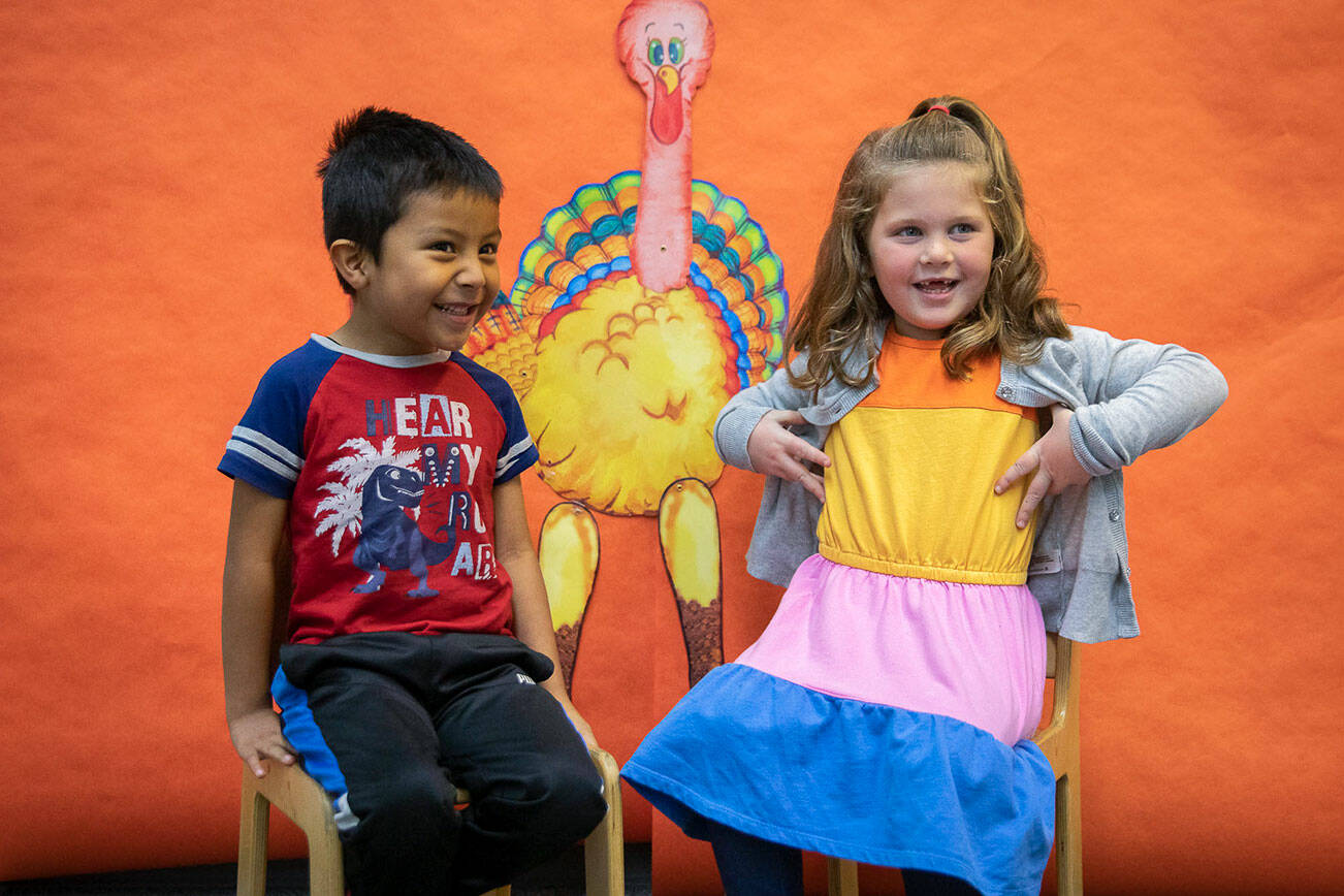 Jake Martinez-Torralba, left, smiles while and Evelyn Ward, right, does her best impression of a turkey at Central Primary School on Tuesday, Nov. 22, 2022 in Snohomish, Washington. (Olivia Vanni / The Herald)