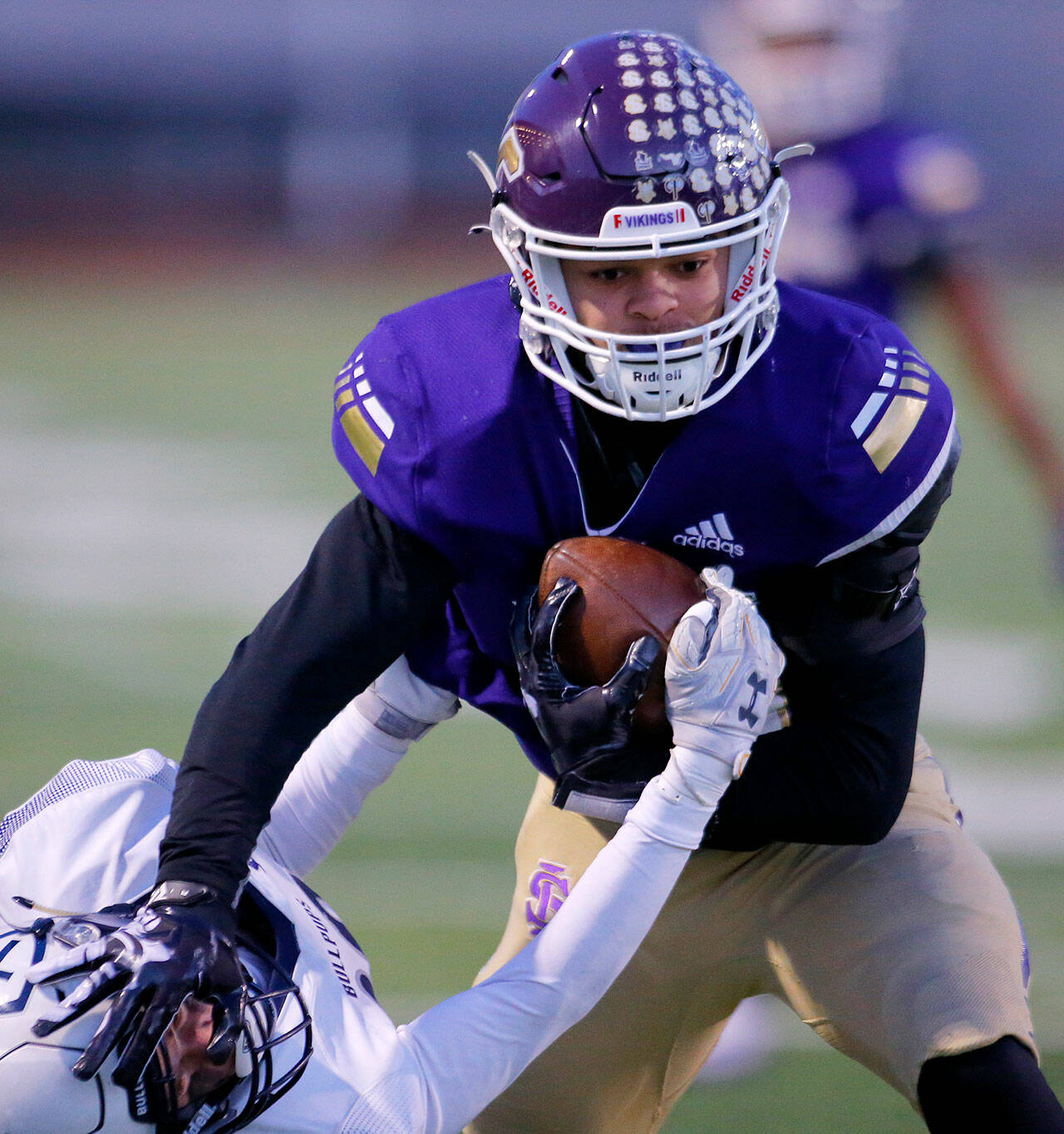 Lake Stevens star running back Jayden Limar stiff-arms a defender to the ground en route to one of his five touchdowns in the Vikings’ 42-17 state quarterfinal win over Gonzaga Prep on Saturday evening. (Ryan Berry / The Herald)
