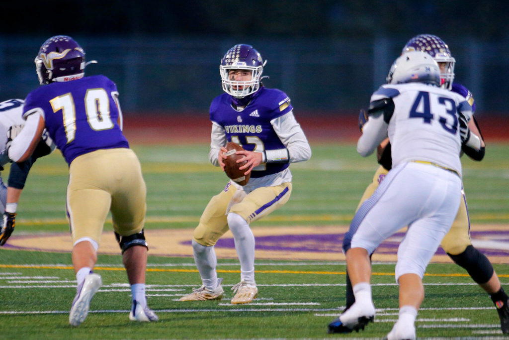 Lake Stevens’ Kolton Matson steps up into the pocket while looking for a receiver against Gonzaga Prep on Saturday, Nov. 19, 2022, at Lake Stevens High School in Lake Stevens, Washington. (Ryan Berry / The Herald)

