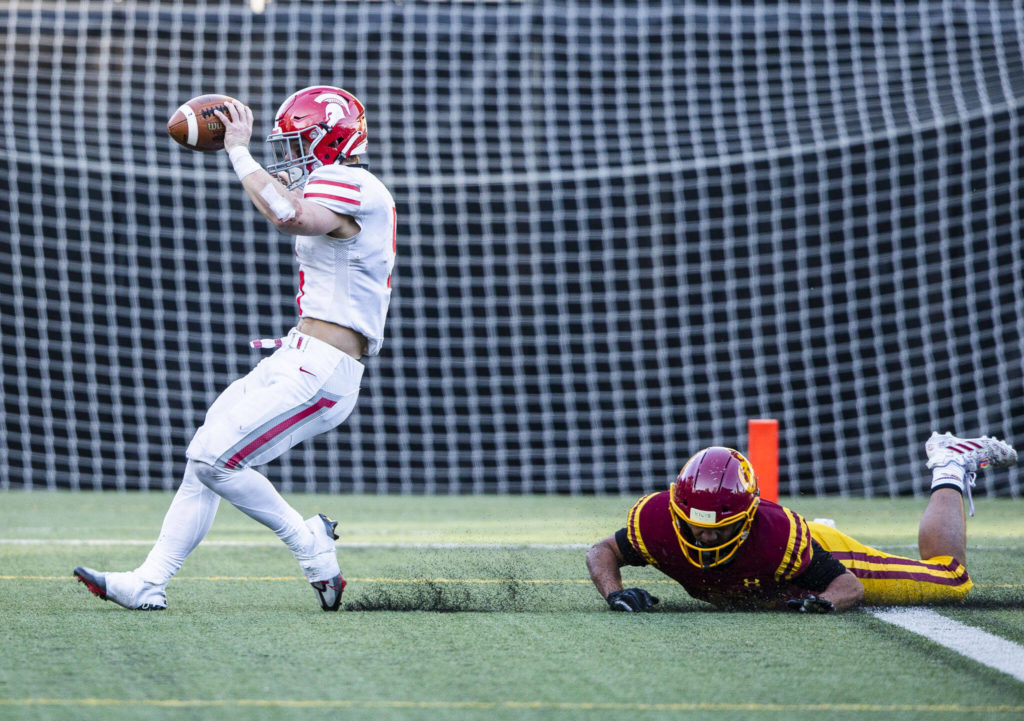 Stanwood’s Ryder Bumgarner runs the ball in for a touchdown during the 3A quarterfinal game against Odea on Saturday, Nov. 19, 2022 in Seattle, Washington. (Olivia Vanni / The Herald)
