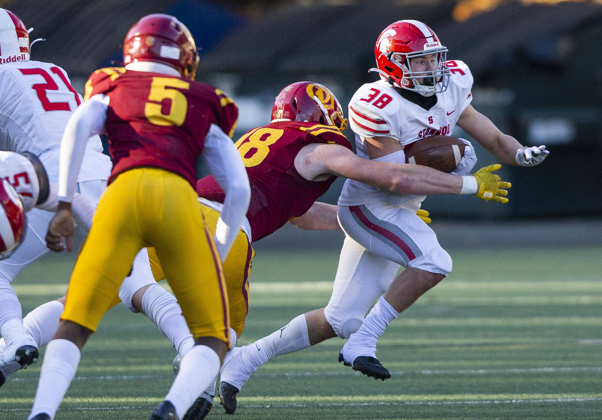 Stanwood’s Carson Beckt is tackled while running the ball during the 3A quarterfinal game against Odea on Saturday, Nov. 19, 2022 in Seattle, Washington. (Olivia Vanni / The Herald)