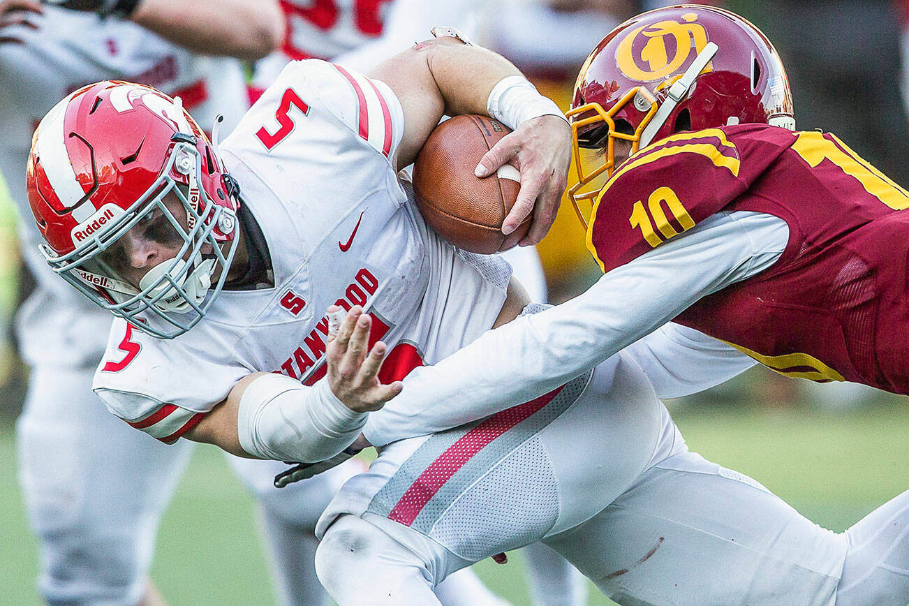 Stanwood’s Ryder Bumgarner is tackled while running the ball during the 3A quarterfinal game against Odea on Saturday, Nov. 19, 2022 in Seattle, Washington. (Olivia Vanni / The Herald)