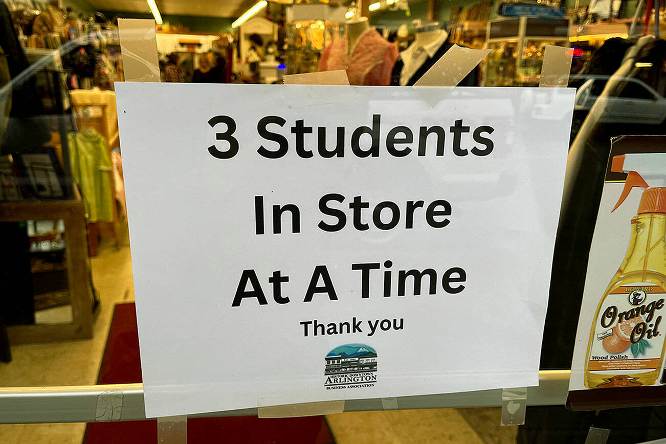 A sign posted on the door of Bits’n Pieces in Arlington. (Jacqueline Allison / The Herald)