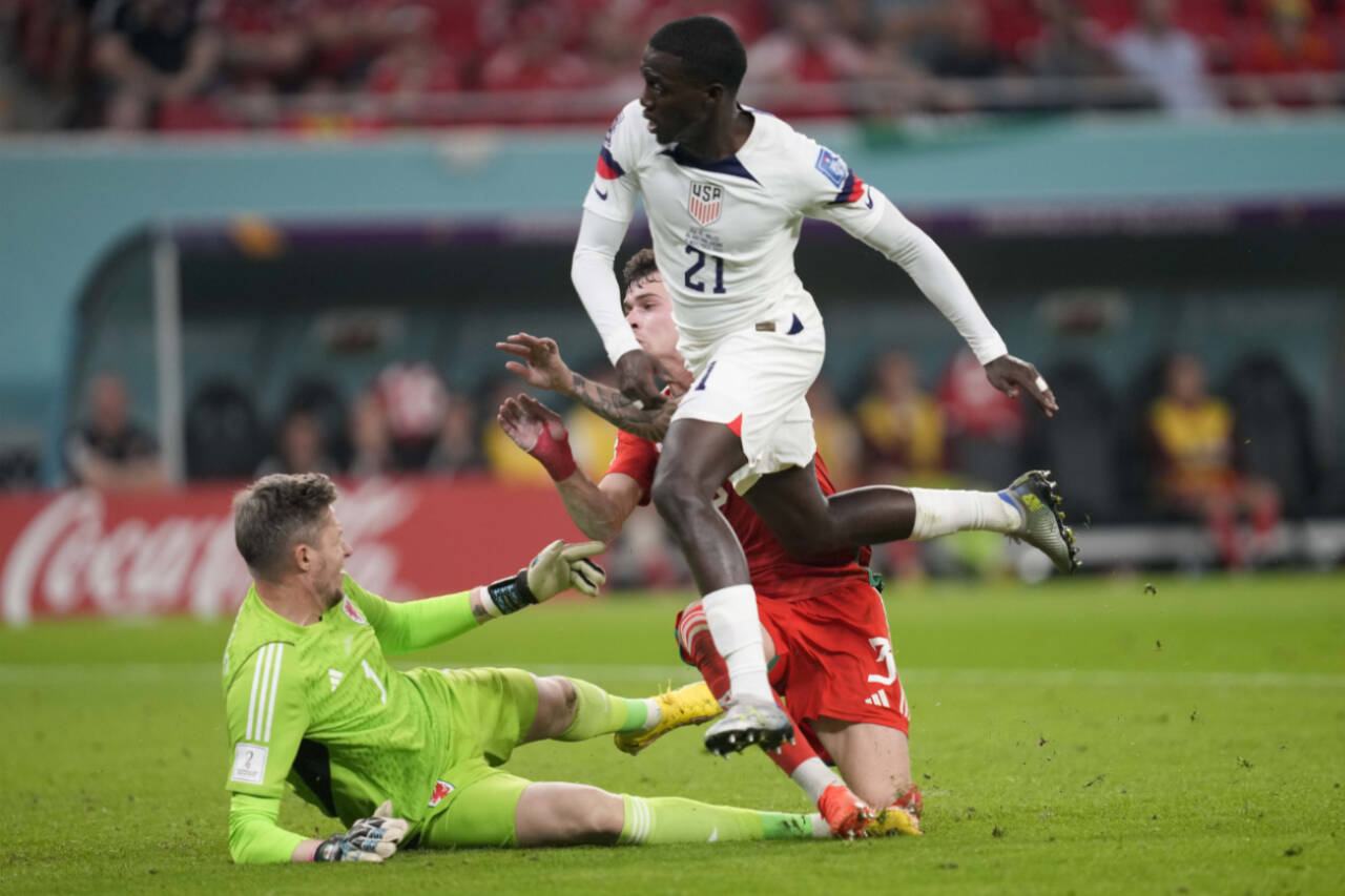 Tim Weah of the United States scores during a World Cup match against Wales on Monday at Ahmad Bin Ali Stadium in in Doha, Qatar. (AP Photo/Darko Vojinovic)