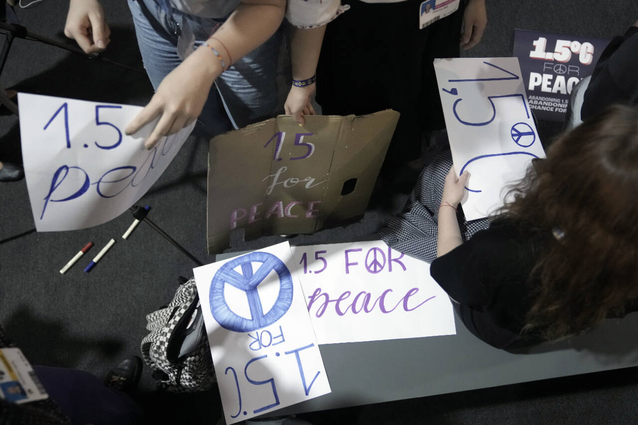 Activists prepare signs for 1.5 degrees Celsius for Peace during a session at the COP27 U.N. Climate Summit, Nov. 17, in Sharm el-Sheikh, Egypt. (Nariman El-Mofty / Associated Press)