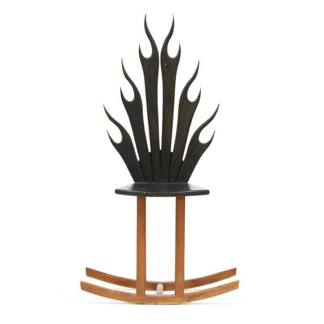 Stylized shapes, light wood, bold blocks of color and unusual construction are characteristics of modern furniture. This flame rocking chair shows all four.