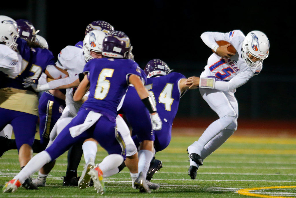 Graham-Kapowsin’s Daveon Superales nearly slips a tackle on a quarterback keeper during the 4A semifinal against Lake Stevens on Saturday, Nov. 26, 2022, at Lake Stevens High School in Lake Stevens, Washington. (Ryan Berry / The Herald)
