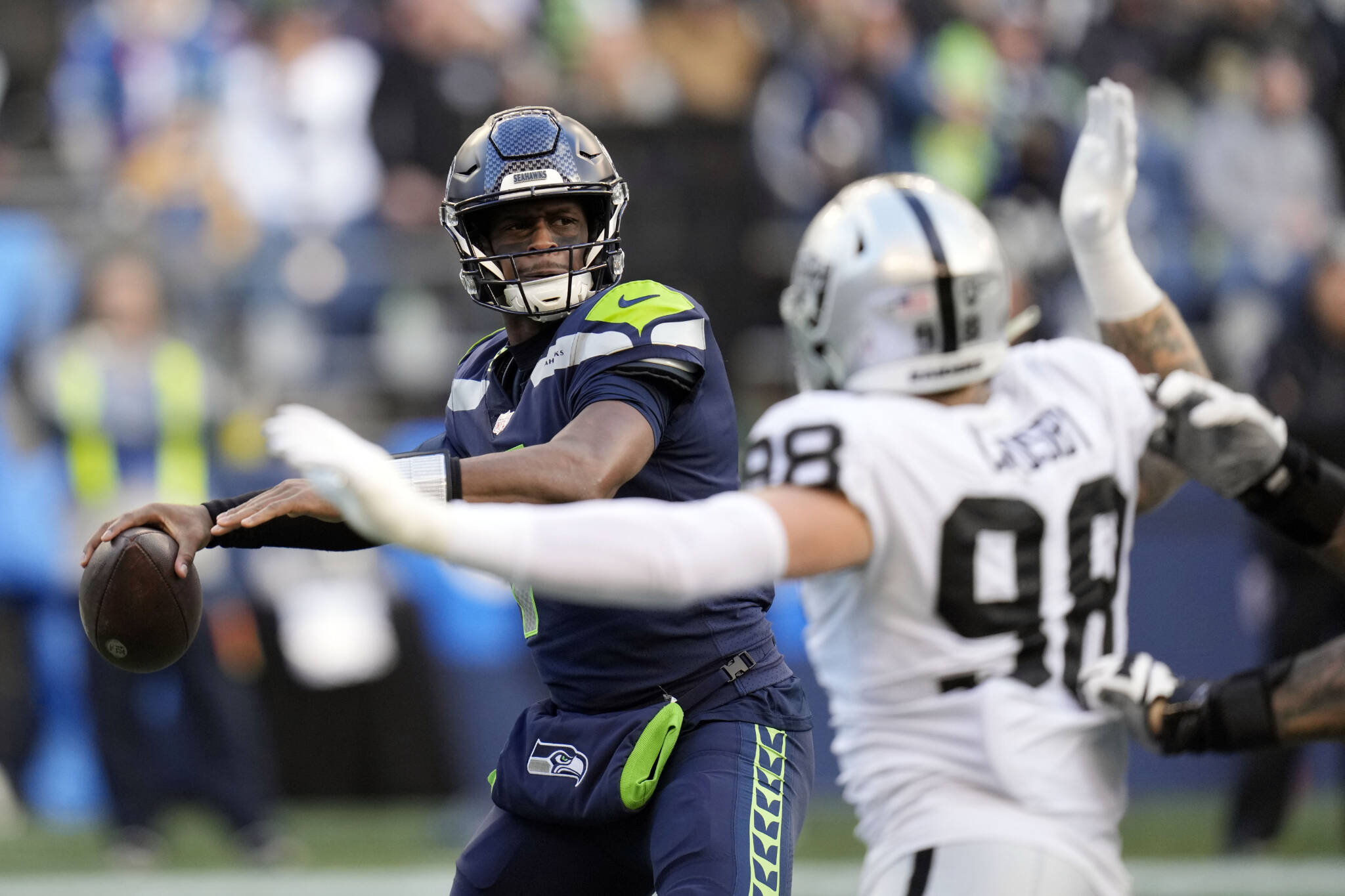 Seahawks quarterback Geno Smith throws against the Raiders during the second half of a game Sunday in Seattle. (AP Photo/Gregory Bull)