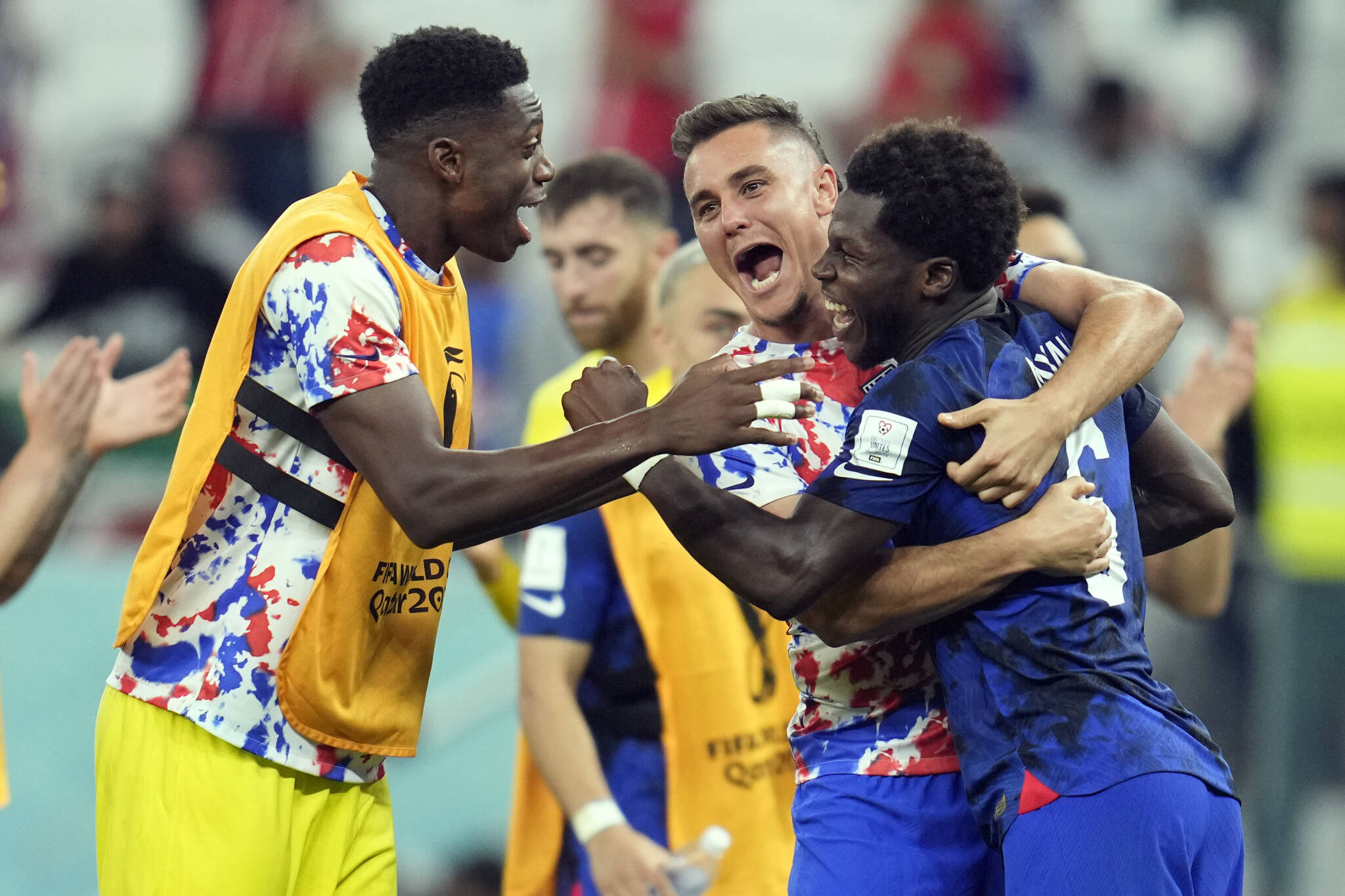 The United States’ Yunus Musah (right), Aaron Long (center) and Sean Johnson celebrate after defeating Iran in a World Cup Group B match on Tuesday at the Al Thumama Stadium in Doha, Qatar. (AP Photo/Ashley Landis)