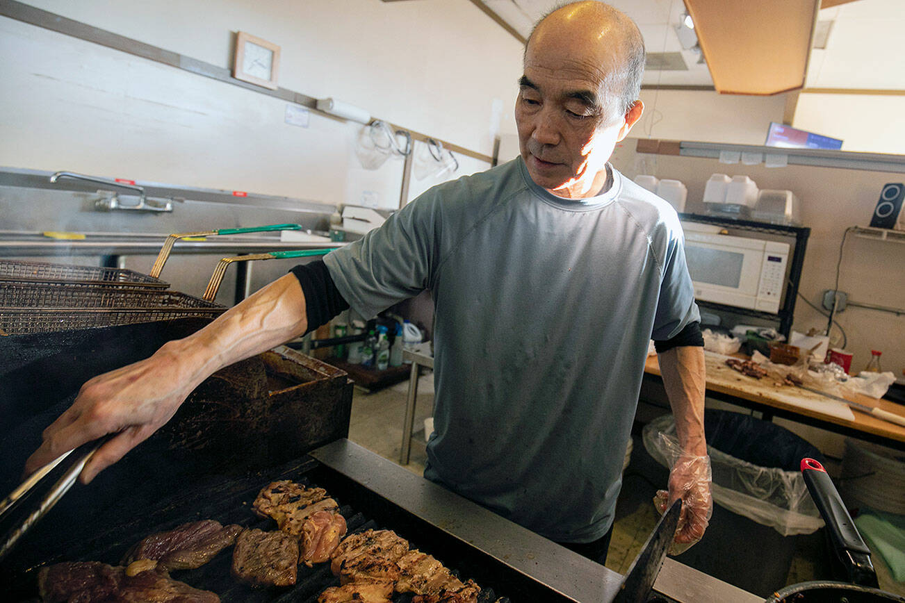 Toshihiro Kasahara works the grill on Wednesday, Jan. 26, 2022, at Toshi’s Teriyaki in Mill Creek. (Ryan Berry / The Herald)