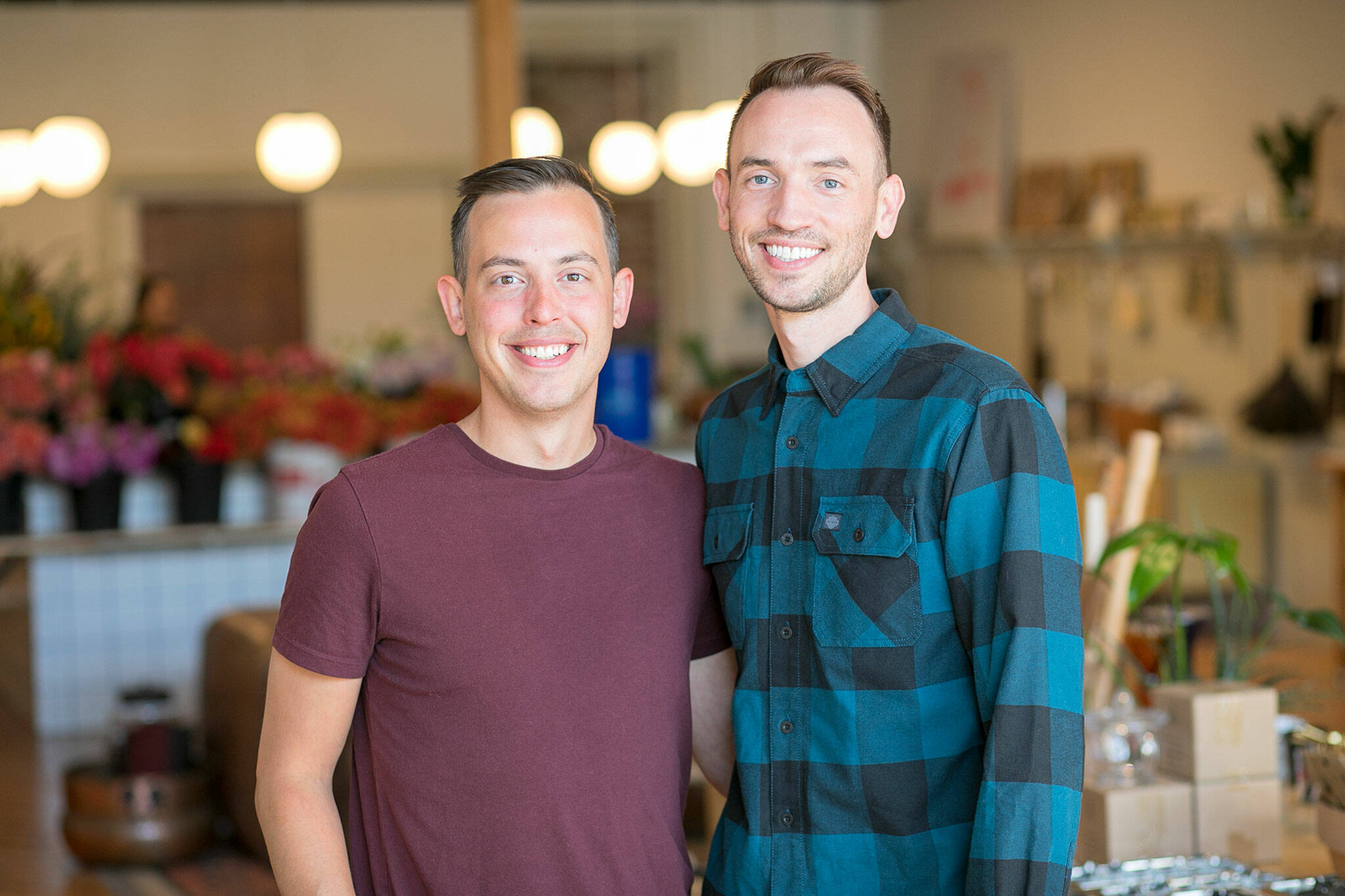 Petrikor co-owners Aaron Sheckler and Scott Hulme stand inside the entrance of their new modern general store on Sep. 18, in downtown Everett. (Ryan Berry / The Herald)