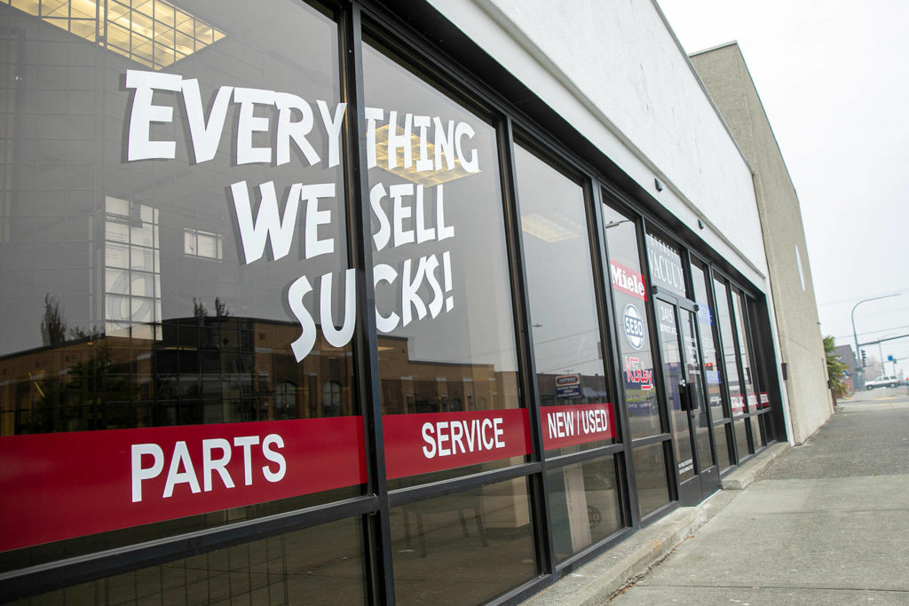 Everett Vacuum’s new Hewitt location displays their classic “Everything we sell sucks” motto on the front window. (Ryan Berry / The Herald)
